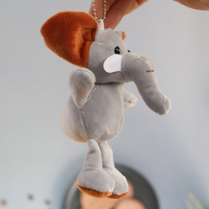 Détail d'un porte-clés éléphant en peluche grise avec oreilles brunes et chaîne