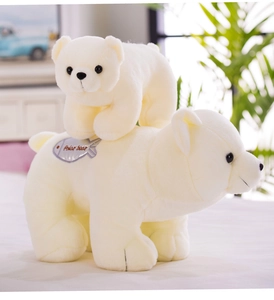 Close-up of plush polar bear duo with fish embroidery and soft white faux fur texture
