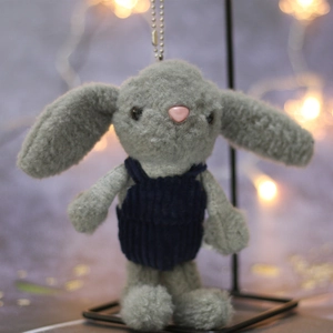 Plush bunny keychain detail featuring dark blue corduroy overalls and soft grey fur