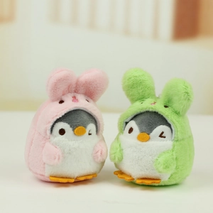 Detail of plush penguin charms wearing pink and green bunny hats for bags or keys