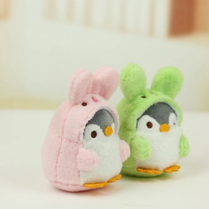 Detail of plush penguin keychains wearing pink rabbit and green round ear hoods