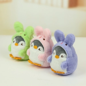 Detailed view of three mini plush penguin pendants with rabbit hoods in pastel colors