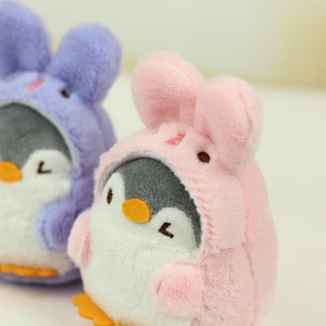 Close-up of soft penguin plush pendant featuring cute rabbit-eared hoodie and embroidery