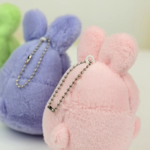 Close-up of colorful plush rabbit pendants with fluffy texture and metal bead chains