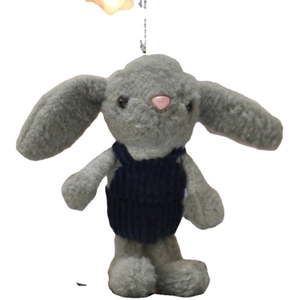Cute long-eared gray plush rabbit wearing dark blue corduroy overalls on white background