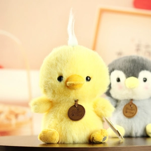 Close-up of cute plush chick and penguin toys featuring soft long-pile faux fur texture
