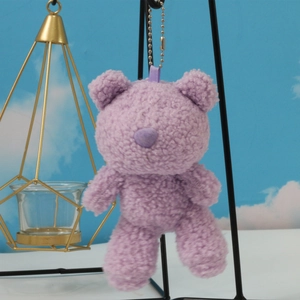 Detail of light purple plush teddy bear keychain with soft faux shearling texture