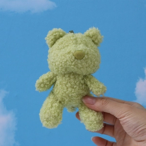 Green plush teddy bear keychain in soft fleece material with brown nose detail