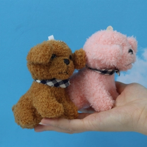 Realistic brown and pink plush teddy dog keychain with checkered scarf held in hand