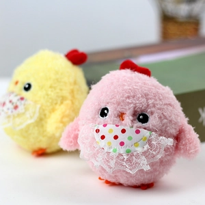Close-up of cute plush chicks with lace bibs and soft fluffy texture for bags