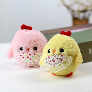 Close-up of cute plush chicks with lace aprons and heart details for backpack charm