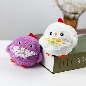 Detail of plush chick pendants with floral lace bibs in purple and white styles