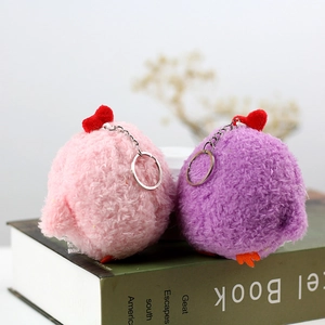 Close-up of pink and purple plush chick keychains with red hearts and metal rings