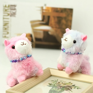 Detail of colorful plush alpaca keychains with beaded necklaces and soft fur texture