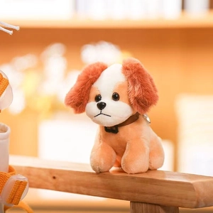 Detail of plush Cavalier King Charles Spaniel dog toy with soft orange and white fur