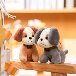 Detailed view of plush dog keychains in brown and grey with soft textured fur