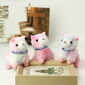 Three colorful alpaca plush keychains with pearl chains and fluffy textured faux fur