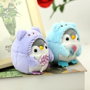 Detail of plush penguin bear pendants with lollipop and ice cream on metal chain
