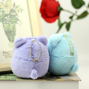 Detail of round plush bear charms in purple and blue with golden bead chains