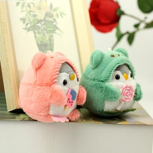 Detail of pink and green plush penguin charms with ice cream accessories and metal hooks