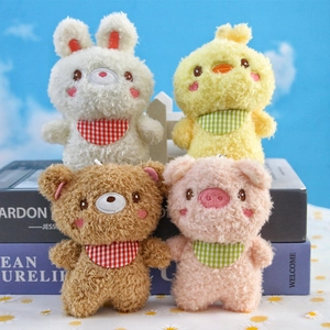 Cute plush animal charms set with rabbit, bear, and chick on decorative books background