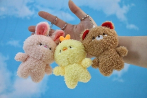 Detail showing plush rabbit, chick, and bear animal pendants with metal keychains