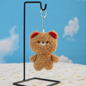 Detail view of light brown sherpa bear keychain with soft texture and silver metal chain