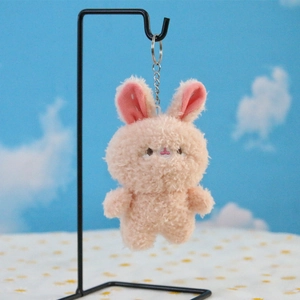 Detailed view of a soft pink plush bunny keychain with silver metal chain for backpacks