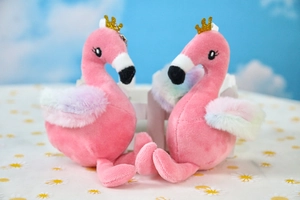 Detail of pink flamingo plush keychain with golden crown and rainbow fluffy wings