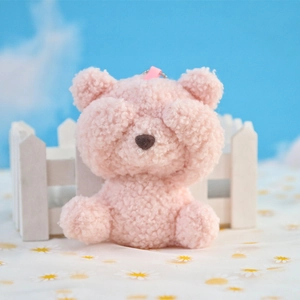 Close-up of pink plush shy bear pendant with soft fuzzy texture and cute hands over eyes