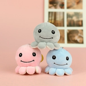 Three cute plush octopus keychains in pink, blue, and gray colors with soft fuzzy texture