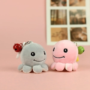 Close-up of cute plush octopus charms with soft fabric, embroidery eyes and small bells