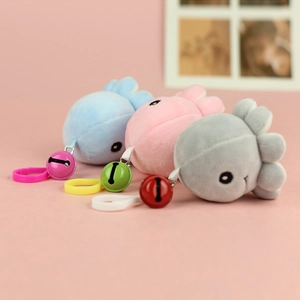 Detailed view of three colorful plush octopus pendants with bells and hooks for bags