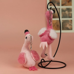 Close-up of cute plush flamingo keychains with soft faux fur texture and metal rings