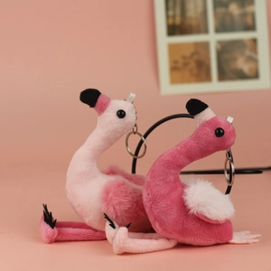 Close-up of cute flamingo plush keychains in pink and rose shades with metal rings