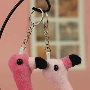 Detail of soft plush flamingo keychains in deep and light pink with silver metal rings