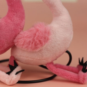 Close-up of pink flamingo plush toy showing soft texture and fine stitching detail