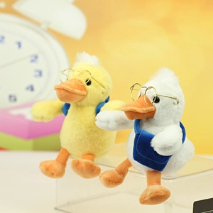 Cute plush duck dolls with glasses and blue bags, available in yellow and white colors