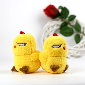 Detail of soft yellow chick plush keychains with funny expressions on a white floral base