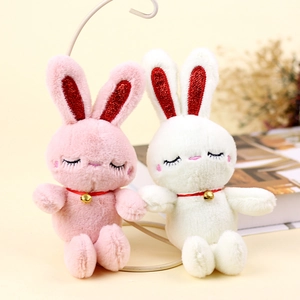 Plush bunny keychains in pink and white with golden bells and glitter ears