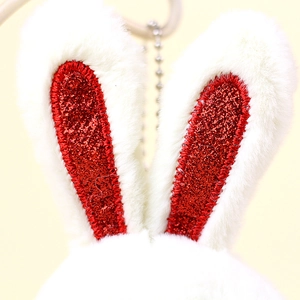 Detail of plush rabbit ears with shiny red sequins and silver metal bead chain