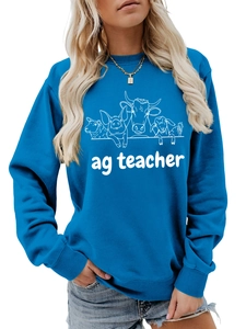Close-up of the agriculture teacher text and cute farm animal sketches on a blue sweatshirt