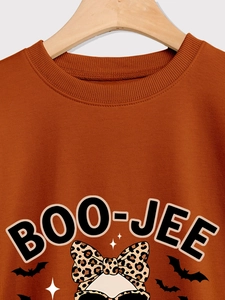 Close-up of Boo-Jee Halloween graphic and leopard print headband on caramel sweatshirt