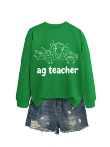 Detail of green ag teacher sweatshirt showing ribbed cuffs and farm animal graphic print