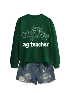 Detail of dark green crewneck sweatshirt with white farm animal print and ag teacher text