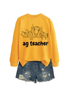 Detail view of yellow sweatshirt with ag teacher farm animal graphics and denim shorts