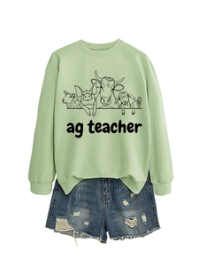 Detail of light green sweatshirt with farm animals and Ag Teacher print and denim shorts