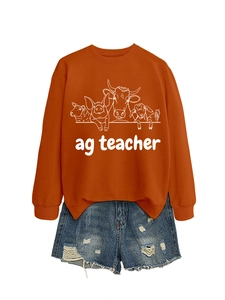 Detail of burnt orange sweatshirt with white farm animal print and ag teacher text