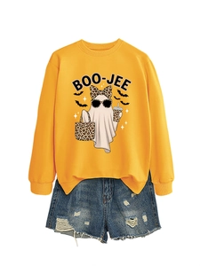 Detail of Boo-Jee ghost print on yellow sweatshirt paired with ripped denim shorts