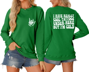 Front and back views of a green crewneck sweatshirt with 'Cool Tattoos' graphic and back text